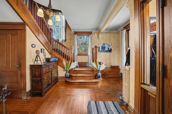 a view of entryway and hall with wooden floor