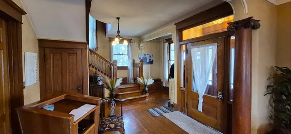 a view of an entryway with wooden floor