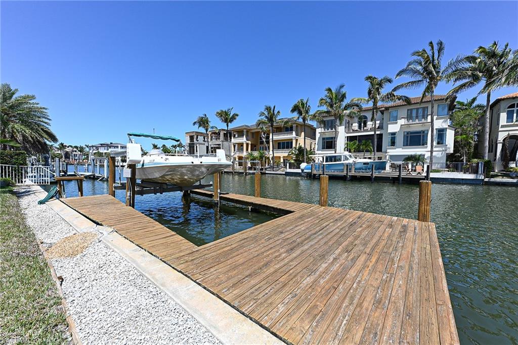 177 Channel Drive Naples, FL 34108 - Photo 21 of 23 a view of a lake with houses