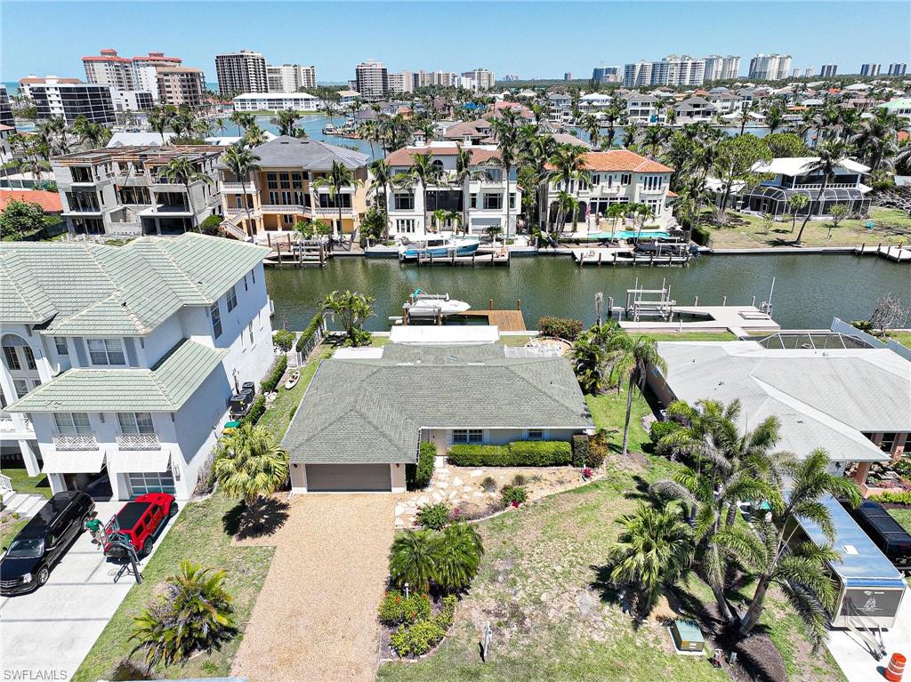 177 Channel Drive Naples, FL 34108 - Photo 3 of 23 an aerial view of a house with a lake view
