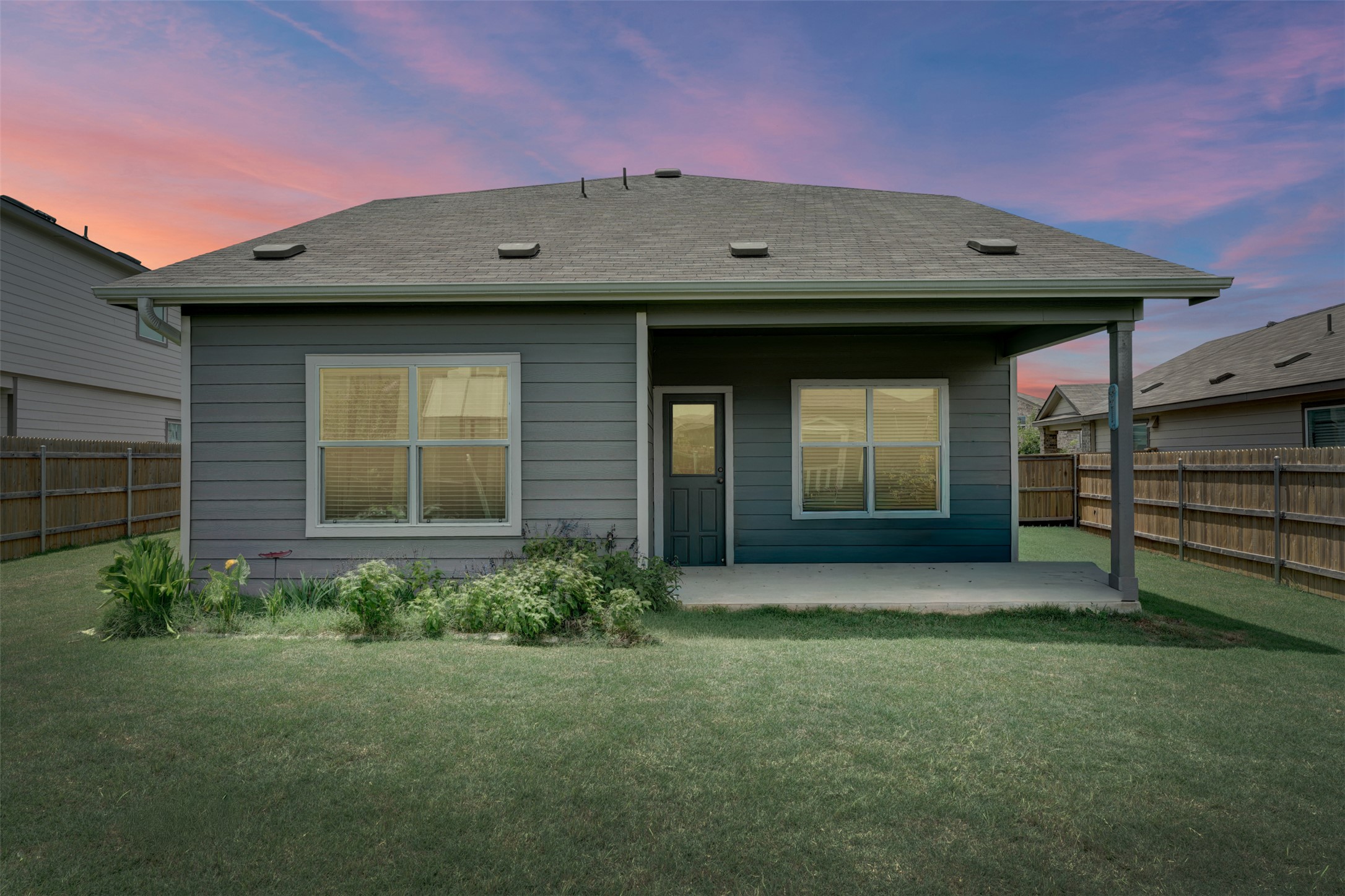 413 Perfect World Loop Jarrell, TX 76537 - Photo 2 of 39 An inviting backyard patio offers a private space for relaxation and enjoyment under an open sky.