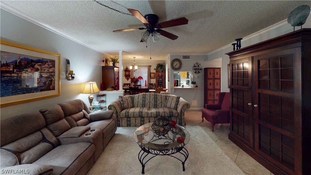 a living room with furniture ceiling fan and a rug