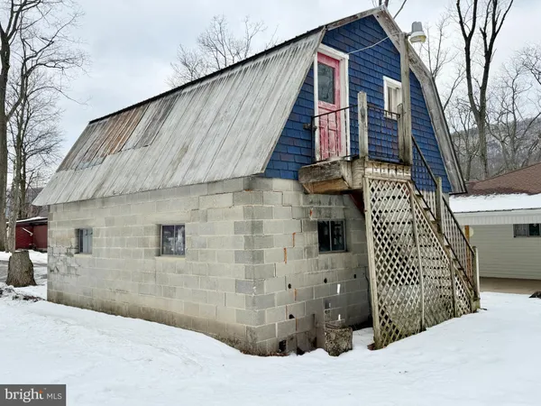 a kitchen with stainless steel appliances kitchen island granite countertop a refrigerator a stove and white cabinets