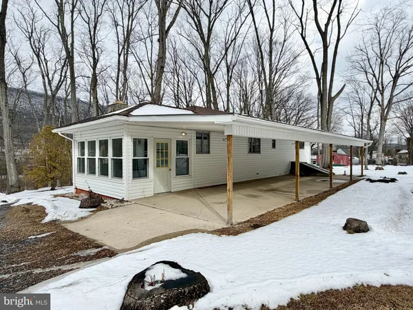 a view of a blue house with a yard