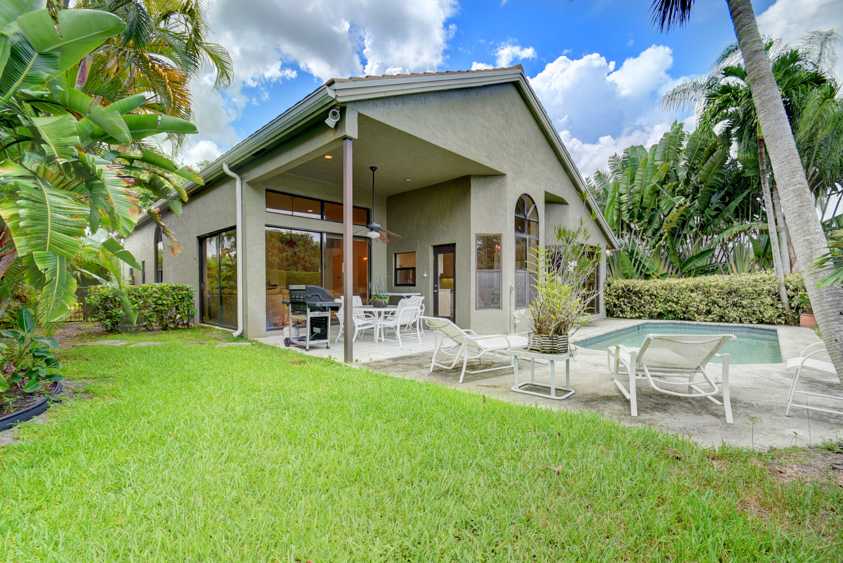 4426 Northwest 29th Way Boca Raton, FL 33434 - Photo 19 of 23 a front view of house with a garden and patio