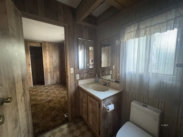 a hallway with a sink and cabinets