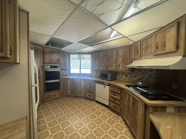 a kitchen with a sink a stove and refrigerator
