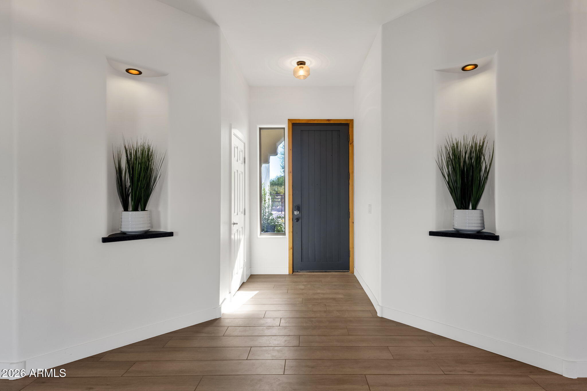 14604 East Peak View Road Scottsdale, AZ 85262 - Photo 5 of 55 a view of a hallway with wooden floor and a bathroom