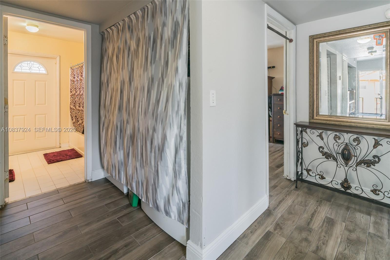 2220 Raleigh Street Hollywood, FL 33020 - Photo 11 of 23 a view of a hallway with wooden floor and a window