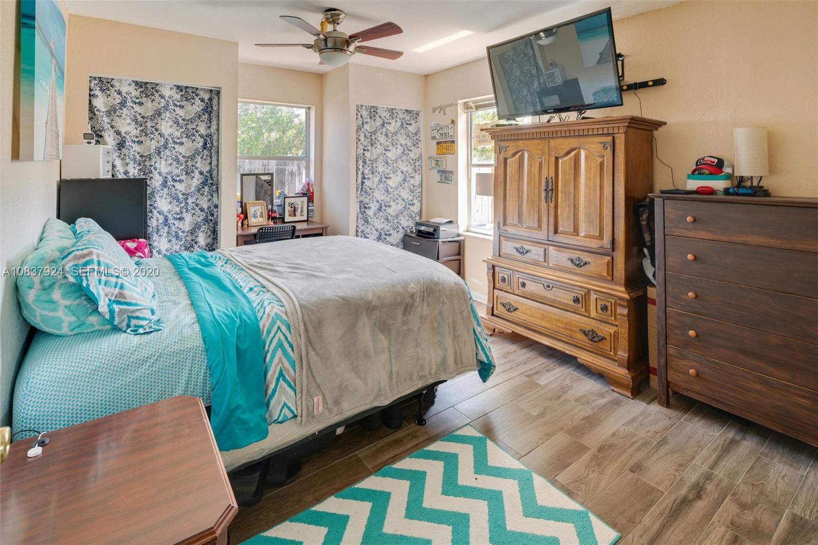 2220 Raleigh Street Hollywood, FL 33020 - Photo 14 of 23 a bedroom with a bed dresser and flat screen tv