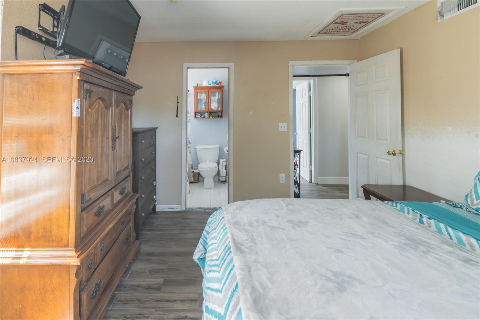 2220 Raleigh Street Hollywood, FL 33020 - Photo 15 of 23 a bedroom with a bed and wooden floor
