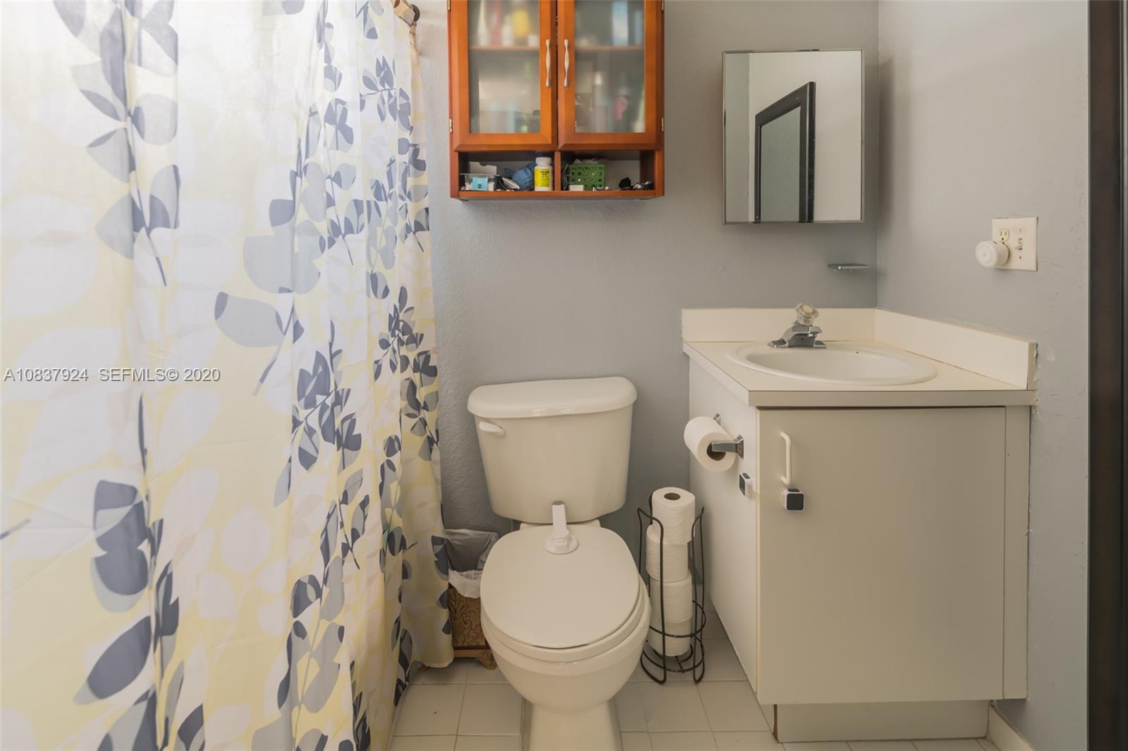 2220 Raleigh Street Hollywood, FL 33020 - Photo 16 of 23 a bathroom with a sink a toilet and a mirror