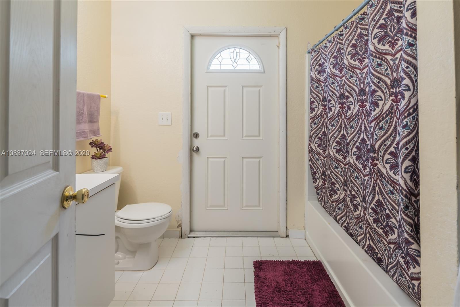 2220 Raleigh Street Hollywood, FL 33020 - Photo 18 of 23 a bathroom with a toilet and a shower curtain