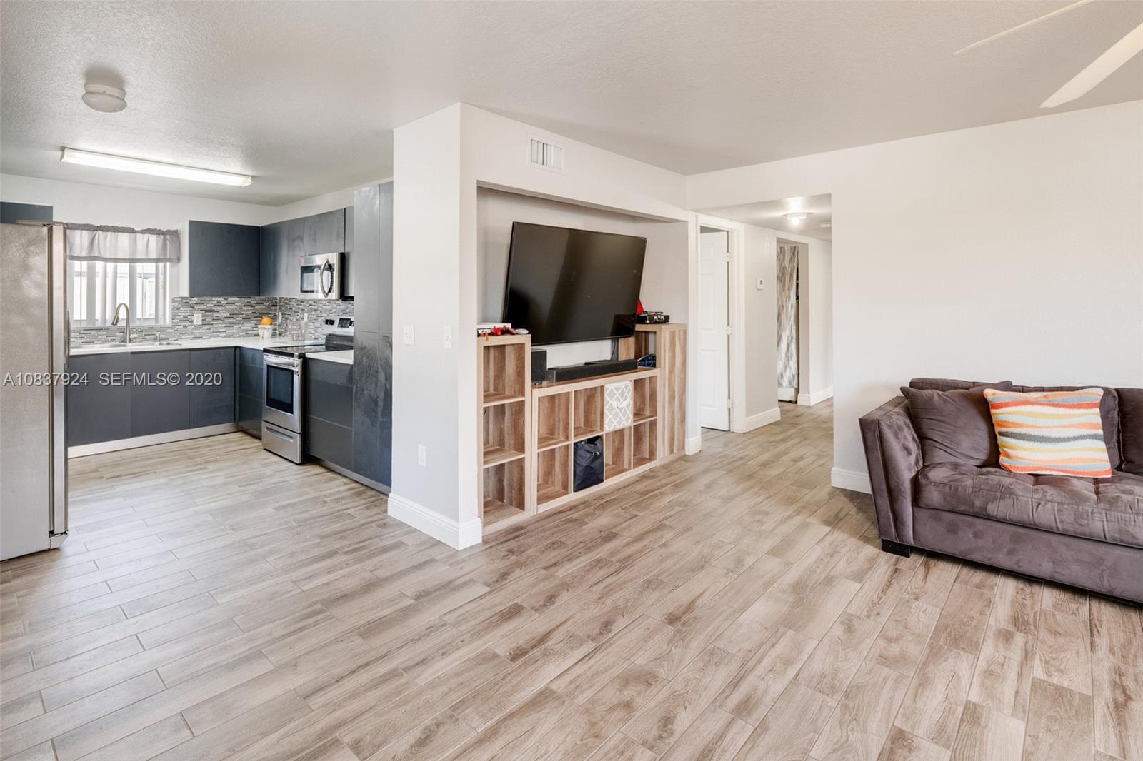 2220 Raleigh Street Hollywood, FL 33020 - Photo 6 of 23 a living room with stainless steel appliances furniture and a flat screen tv