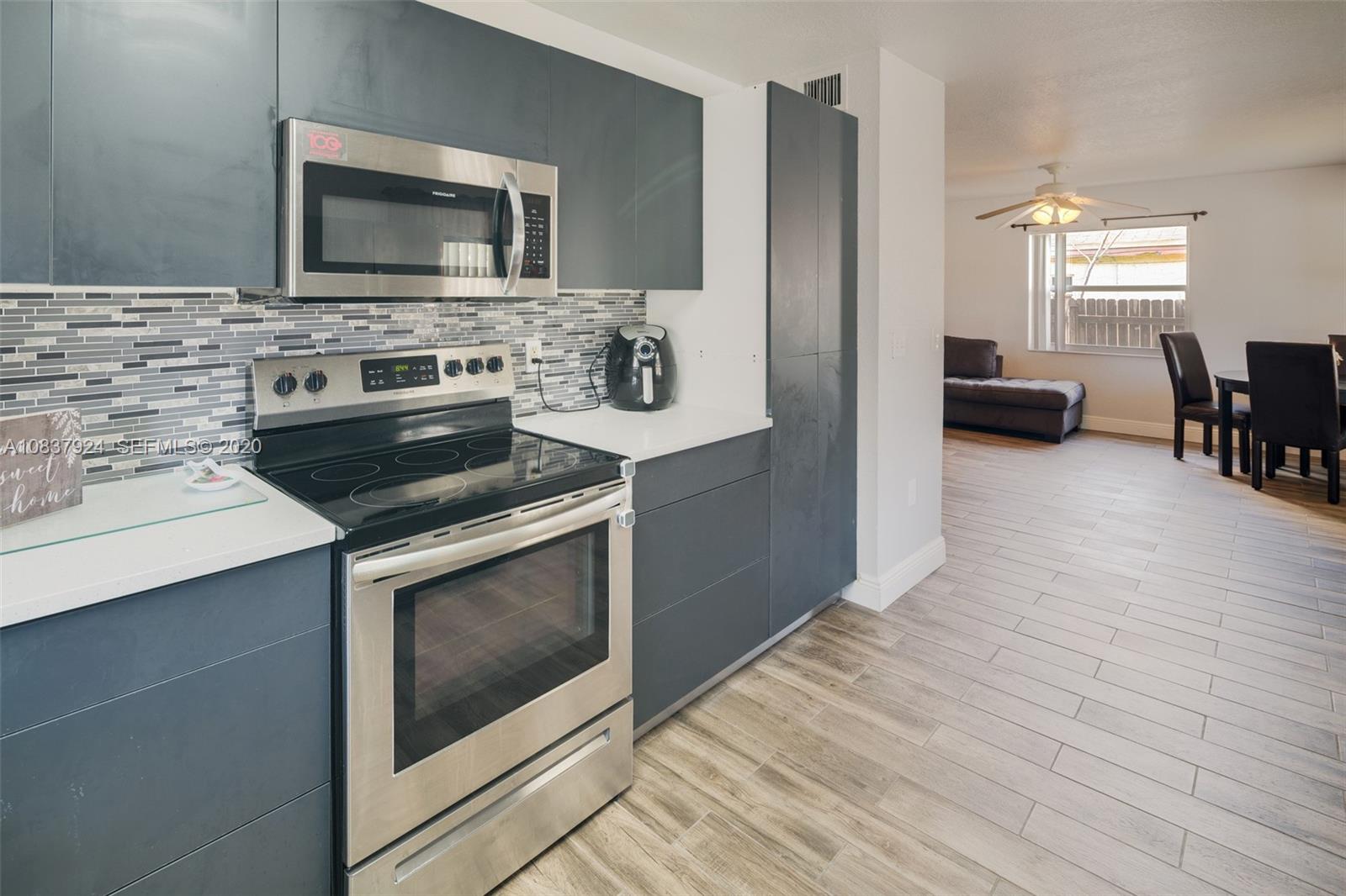 2220 Raleigh Street Hollywood, FL 33020 - Photo 7 of 23 a kitchen with a stove and a microwave