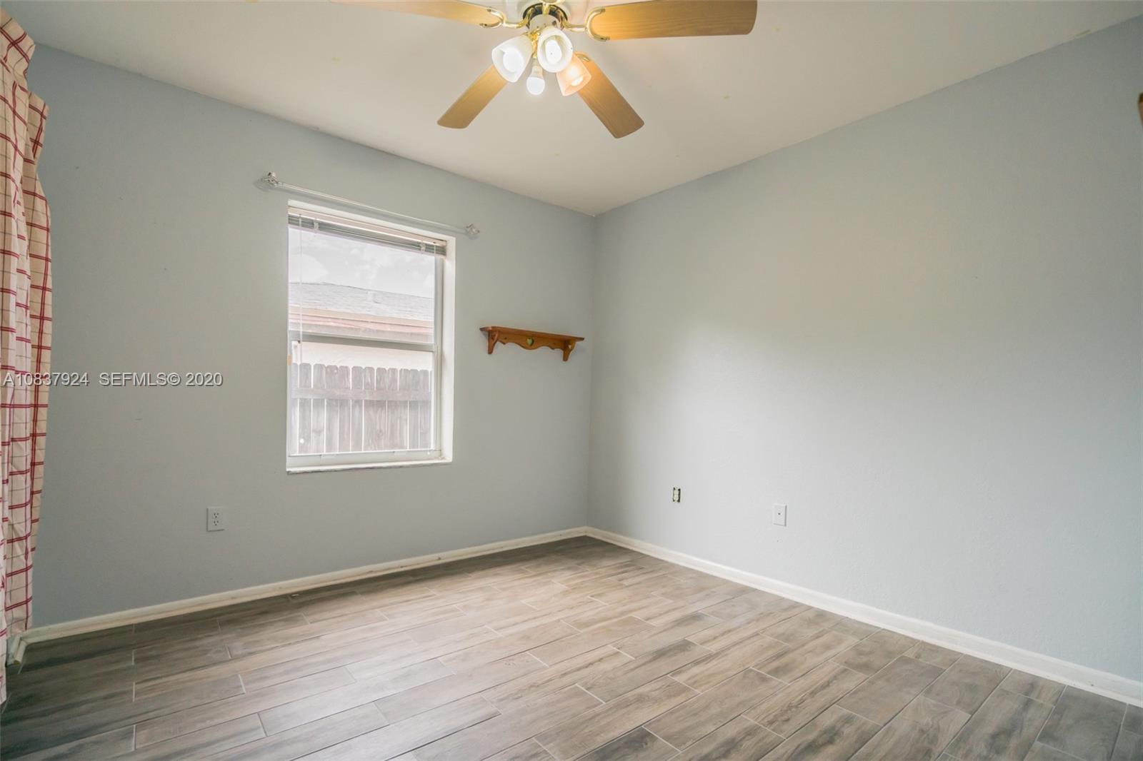 2220 Raleigh Street Hollywood, FL 33020 - Photo 8 of 23 an empty room with wooden floor and windows
