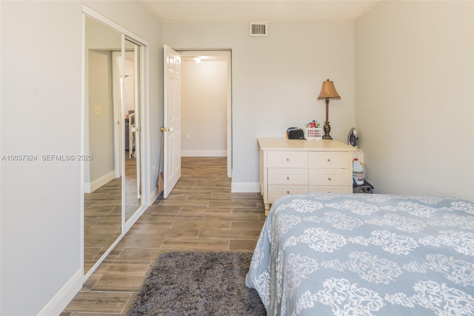 2220 Raleigh Street Hollywood, FL 33020 - Photo 9 of 23 a room with a bed and a mirror