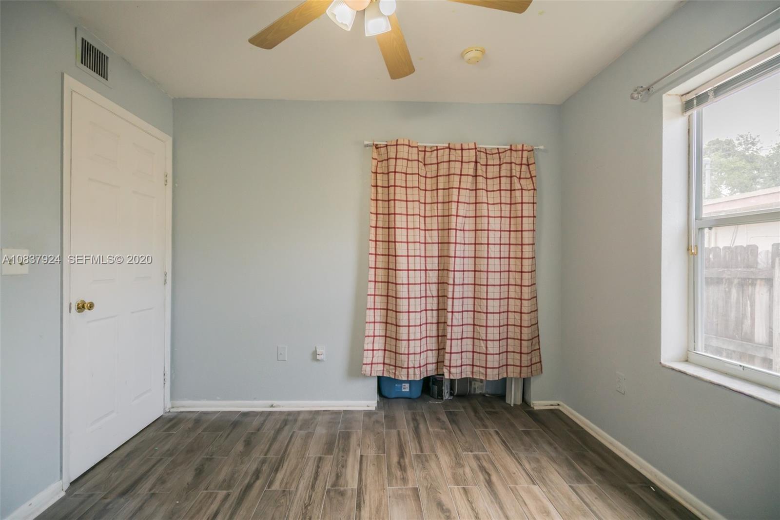 2220 Raleigh Street Hollywood, FL 33020 - Photo 10 of 23 an empty room with wooden floor and windows