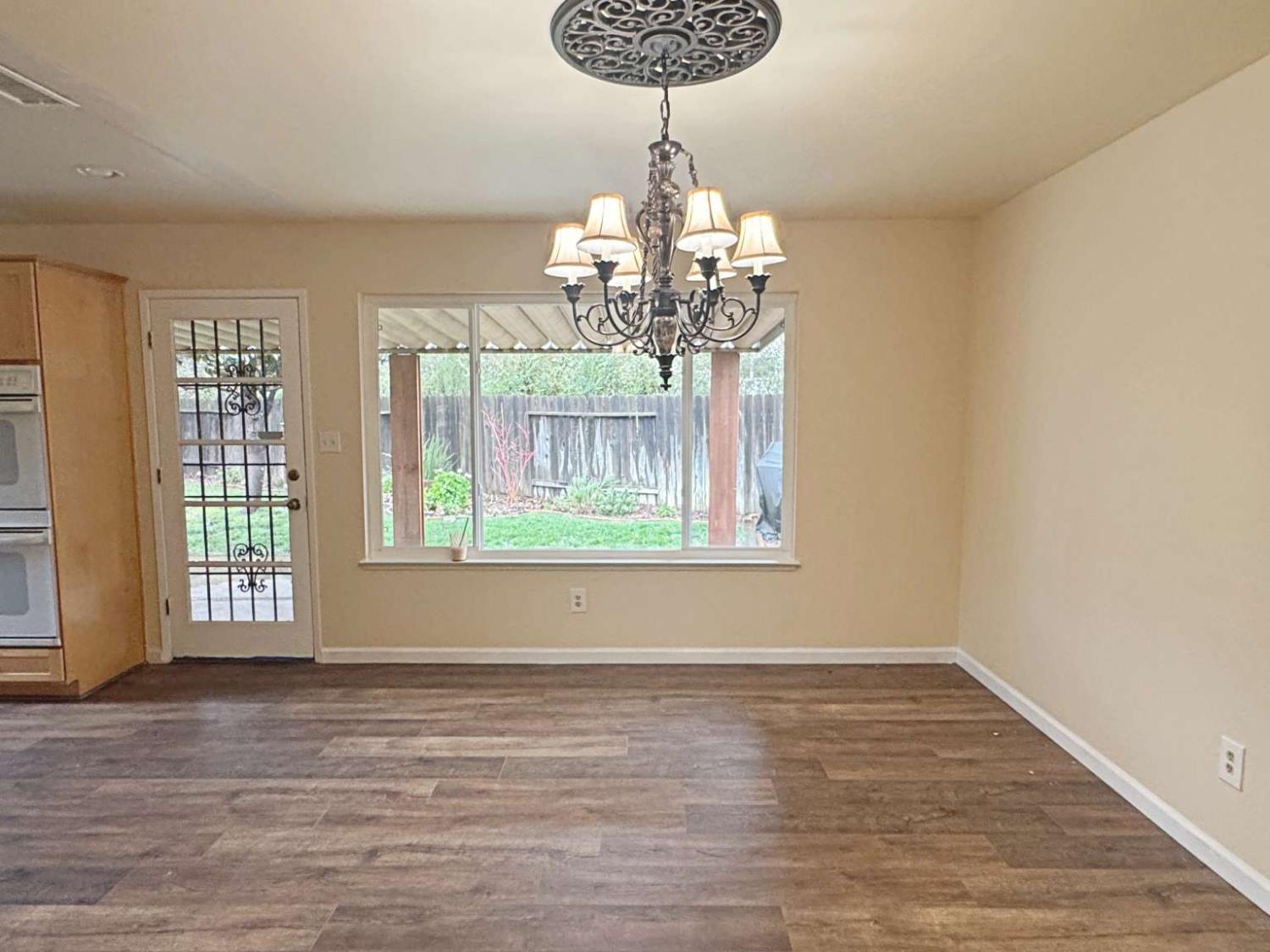 6249 Sunmist Way Citrus Heights, CA 95621 - Photo 16 of 24 a view of a room with wooden floor chandelier and windows
