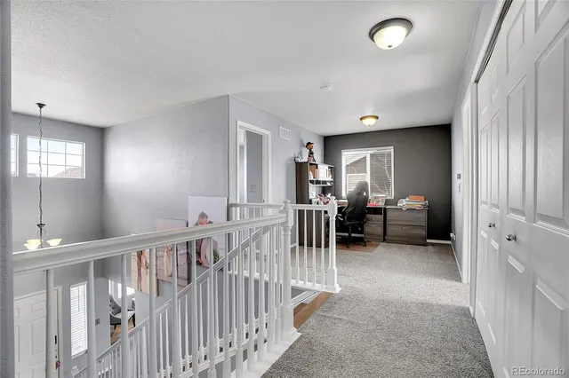 a view of a storage room with an entryway and chandelier