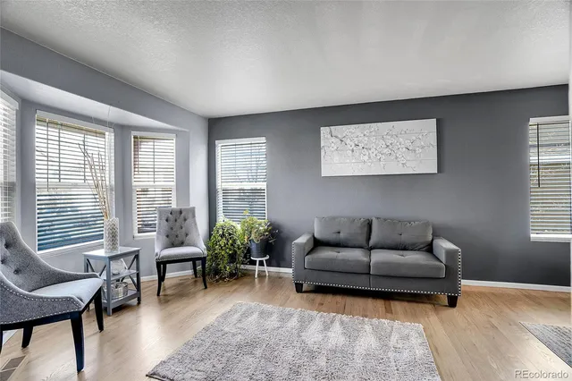 a view of a dining room with furniture window and wooden floor