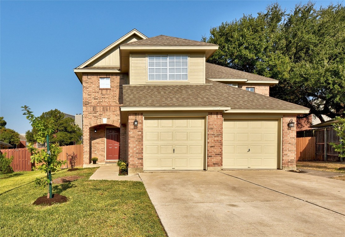 a front view of a house with a yard and garage
