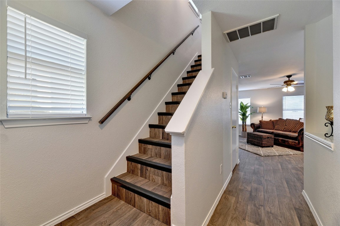 9716 Sugar Hill Drive, Unit A Austin, TX 78748 - Photo 15 of 40 Stairway with wood finished floors, a ceiling fan, and a textured wall