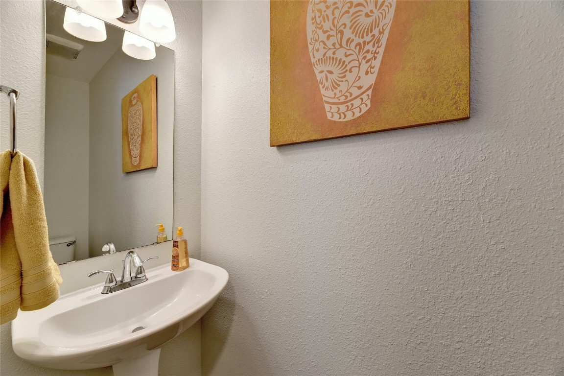 9716 Sugar Hill Drive, Unit A Austin, TX 78748 - Photo 16 of 40 a bathroom with a sink and a mirror