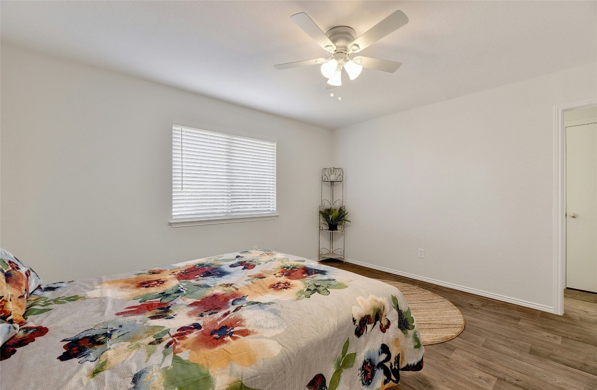 9716 Sugar Hill Drive, Unit A Austin, TX 78748 - Photo 19 of 40 a bedroom with a bed and a chandelier