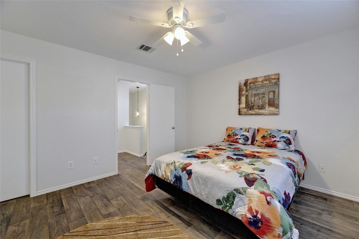 9716 Sugar Hill Drive, Unit A Austin, TX 78748 - Photo 20 of 40 a bedroom with bed and a chandelier