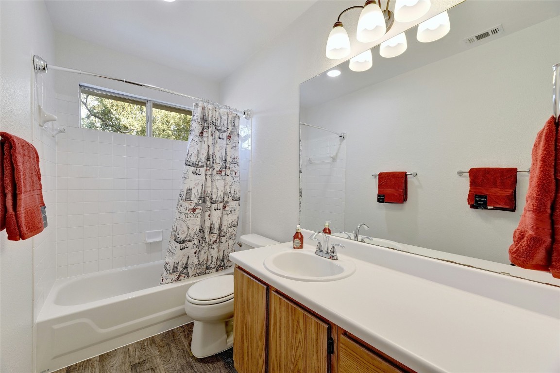 9716 Sugar Hill Drive, Unit A Austin, TX 78748 - Photo 21 of 40 Bathroom with shower / tub combo, vanity, and dark wood-type flooring