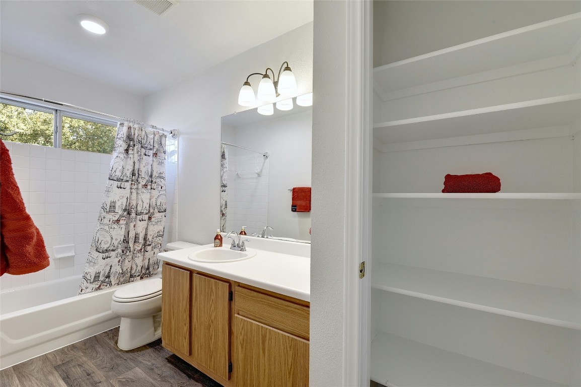 9716 Sugar Hill Drive, Unit A Austin, TX 78748 - Photo 22 of 40 a bathroom with a sink a toilet and shower