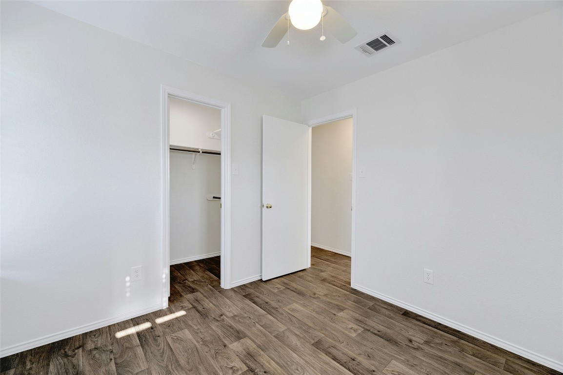 9716 Sugar Hill Drive, Unit A Austin, TX 78748 - Photo 25 of 40 a view of an empty room with wooden floor and a window