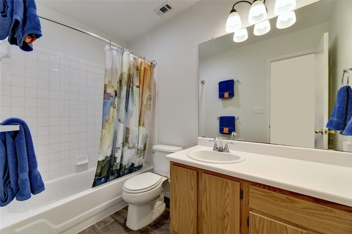 9716 Sugar Hill Drive, Unit A Austin, TX 78748 - Photo 27 of 40 a bathroom with a sink a toilet and a mirror