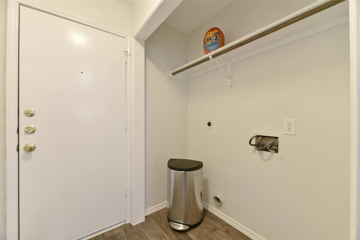 9716 Sugar Hill Drive, Unit A Austin, TX 78748 - Photo 31 of 40 Laundry area with washer hookup, dark wood-style floors, and electric dryer hookup