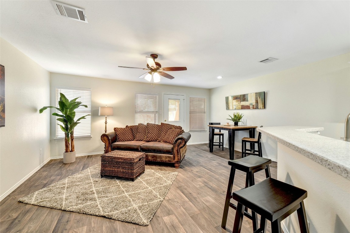 9716 Sugar Hill Drive, Unit A Austin, TX 78748 - Photo 6 of 40 a living room with furniture and a chandelier