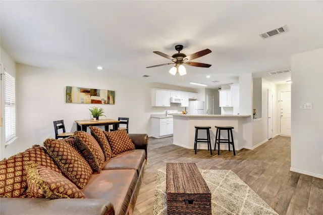a living room with furniture and kitchen view