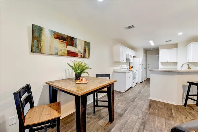 a kitchen with granite countertop a sink stove and refrigerator