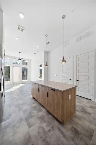 a large white kitchen with cabinets