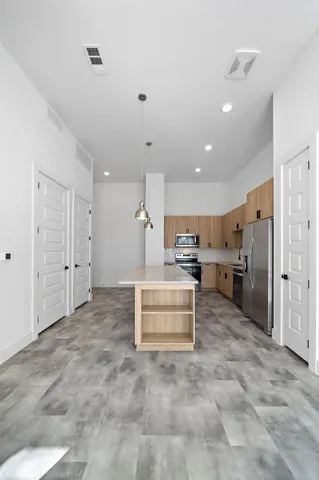 a view of kitchen with refrigerator and window