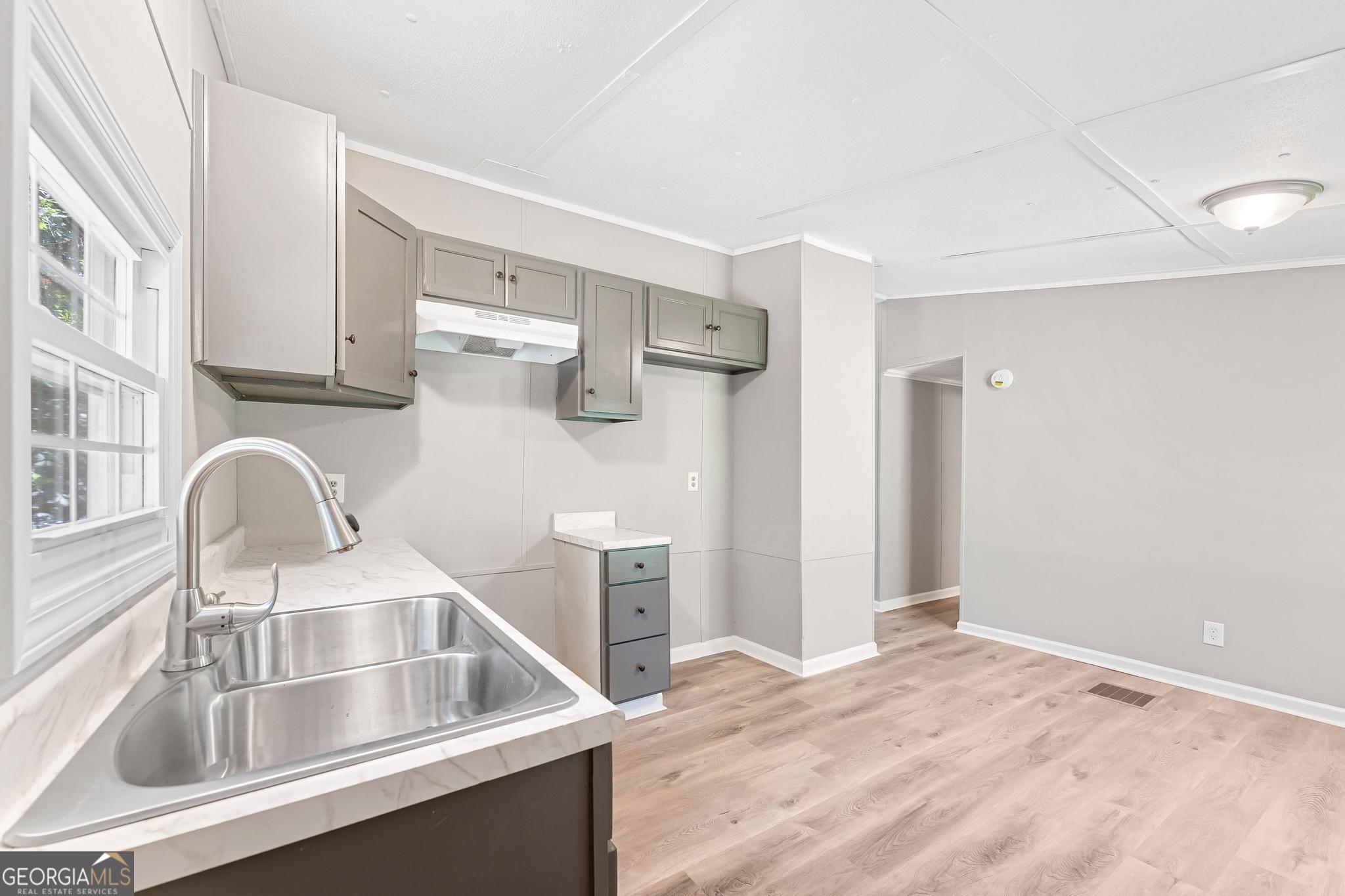 1528 Hodges Mill Road Hartwell, GA 30643 - Photo 12 of 37 a kitchen with a refrigerator sink and cabinets