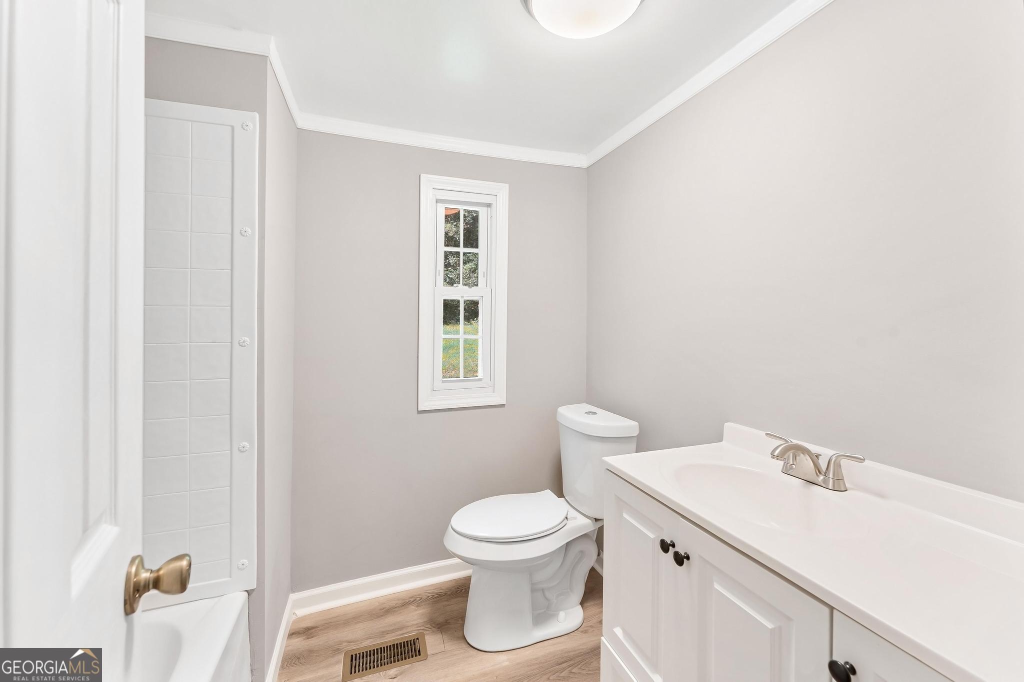 1528 Hodges Mill Road Hartwell, GA 30643 - Photo 16 of 37 a bathroom with a toilet a sink and a window