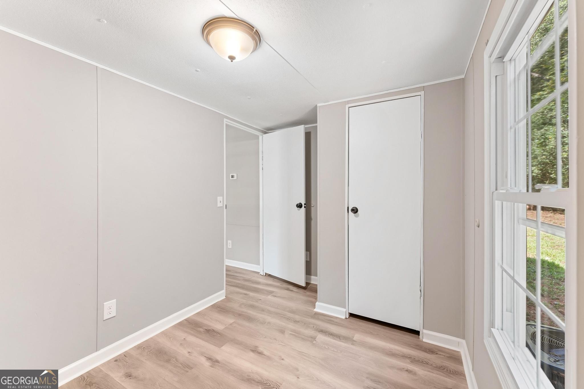 1528 Hodges Mill Road Hartwell, GA 30643 - Photo 23 of 37 a view of empty room with wooden floor and fan