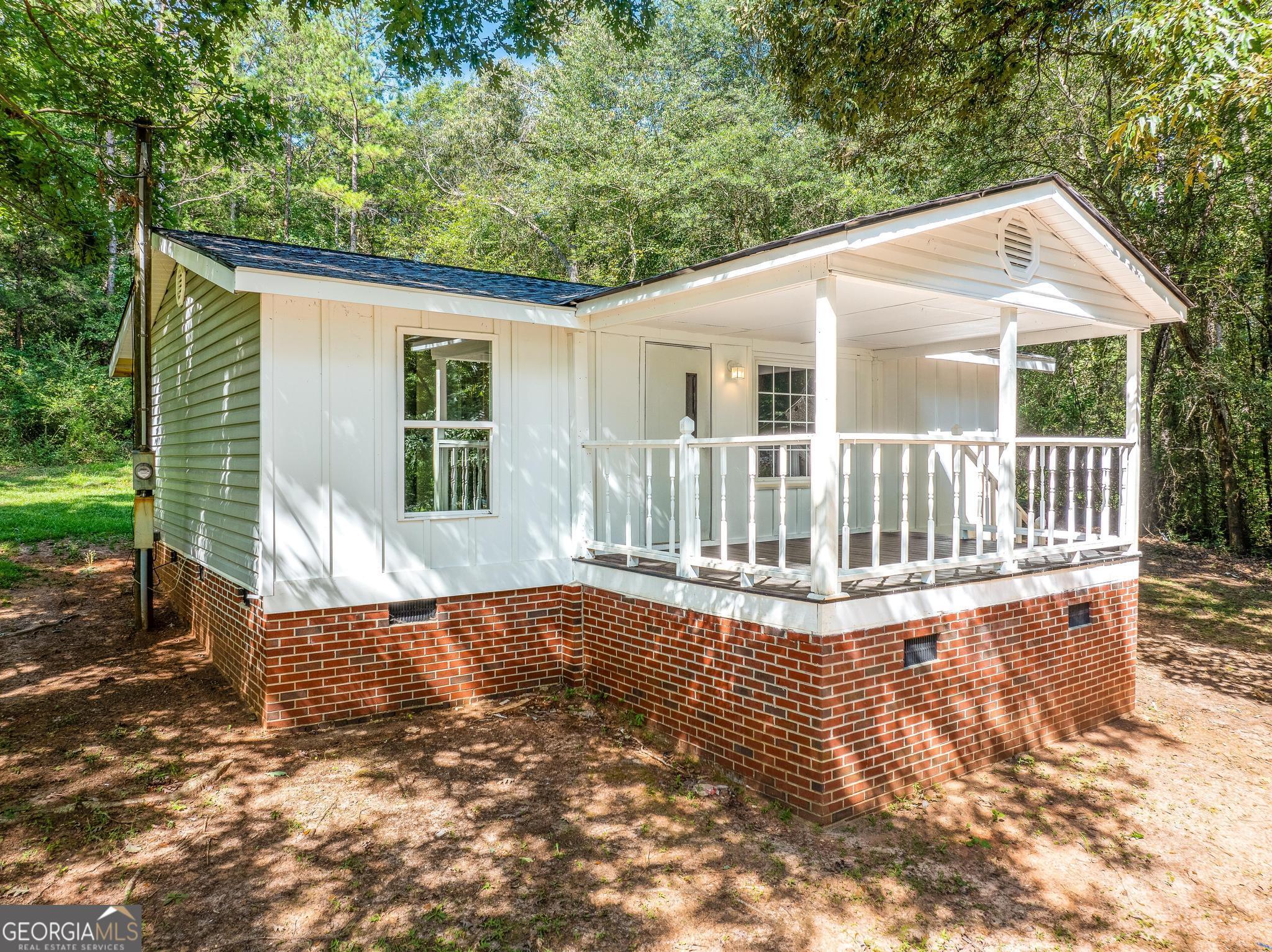 1528 Hodges Mill Road Hartwell, GA 30643 - Photo 33 of 37 a view of a house with backyard and sitting area