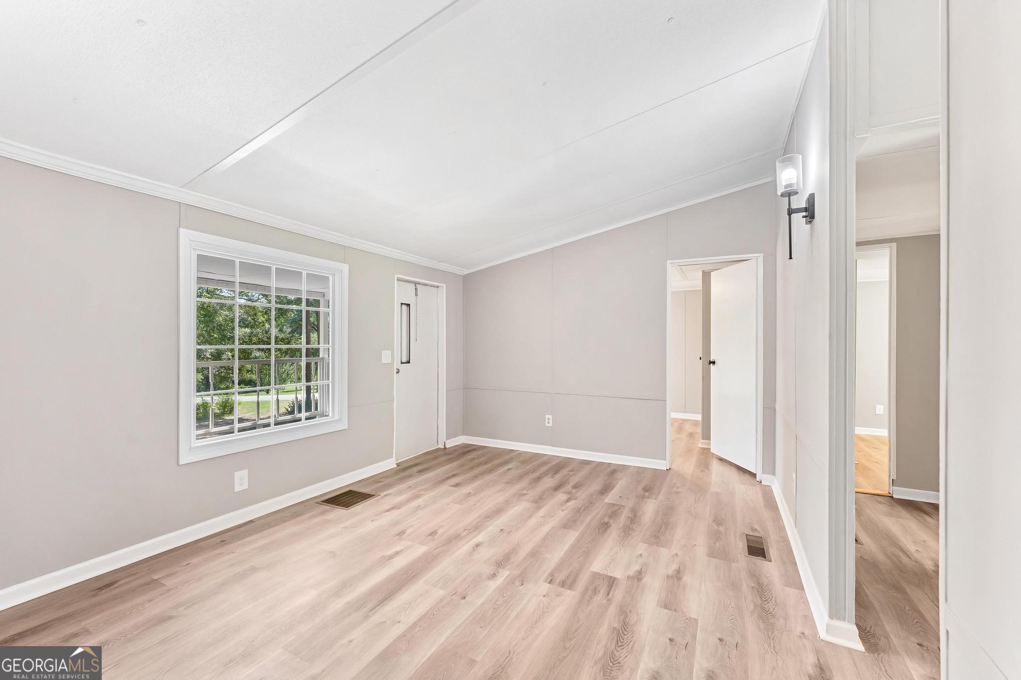 1528 Hodges Mill Road Hartwell, GA 30643 - Photo 8 of 37 a view of an empty room with wooden floor and a window
