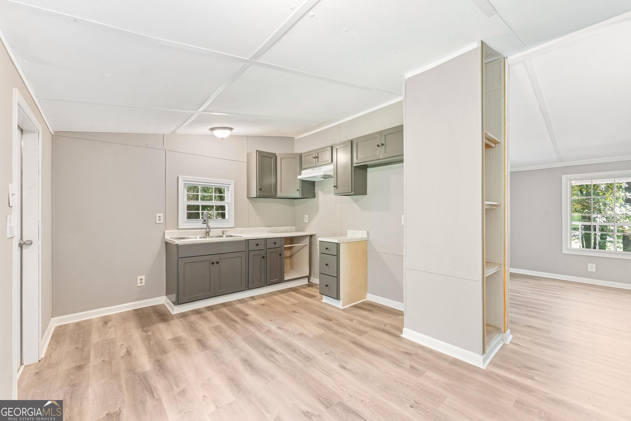 1528 Hodges Mill Road Hartwell, GA 30643 - Photo 9 of 37 a kitchen with a refrigerator sink and cabinets