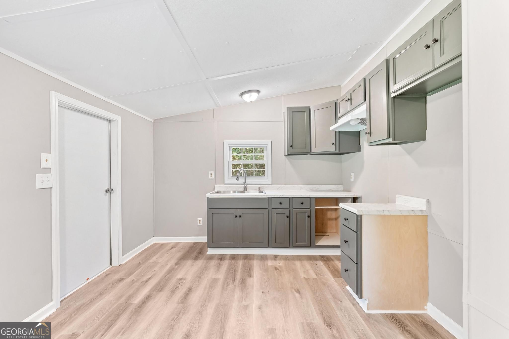 1528 Hodges Mill Road Hartwell, GA 30643 - Photo 10 of 37 a kitchen with a sink stove and refrigerator
