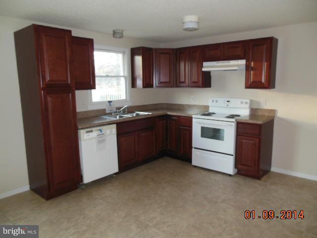 155 Lea Road Colonial Beach, VA 22443 - Photo 2 of 13 a kitchen with a sink a stove and cabinets