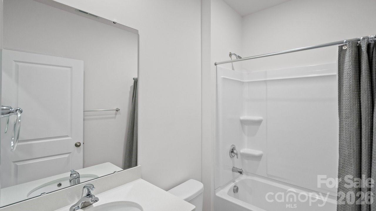 3688 Mercer Street Terrell, NC 28682 - Photo 25 of 34 a bathroom with a granite countertop sink toilet and shower
