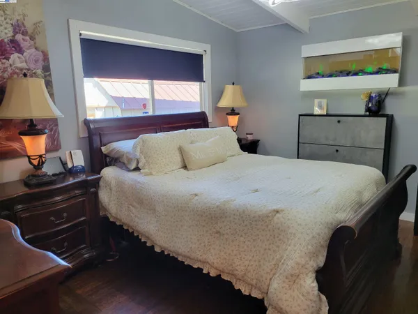 a bedroom with a bed and a window